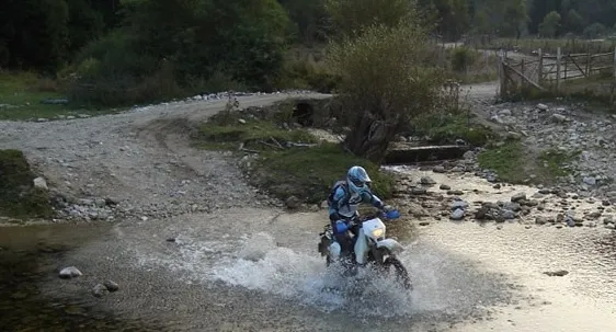 Riding a dual-sport motorcycle across a creek